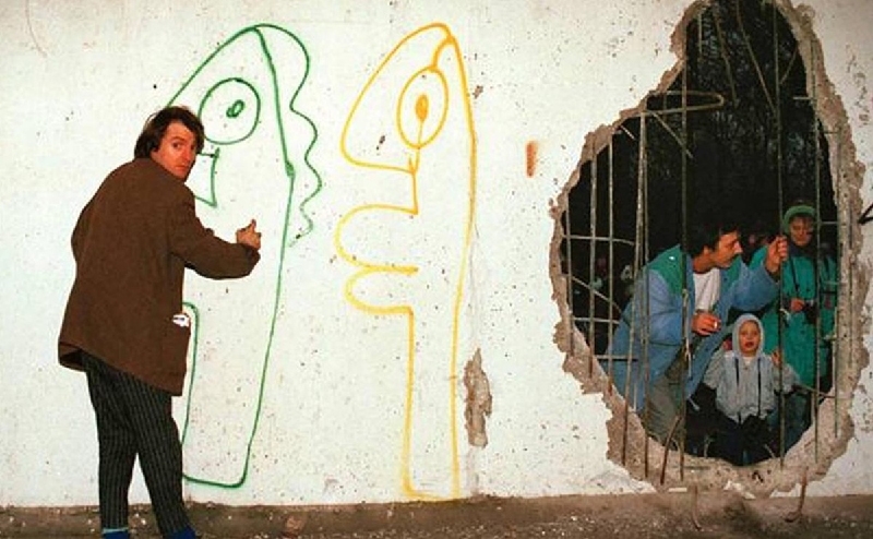 Thierry Noir painting on the Berlin Wall. Image via The Guardian world  urban today view post germany 1961 street art history berlin wall graffiti walls  way  time 